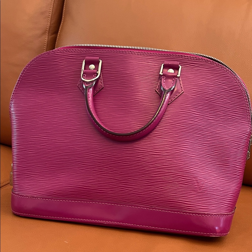 Vintage Louis Vuitton fuchsia Alma bag.